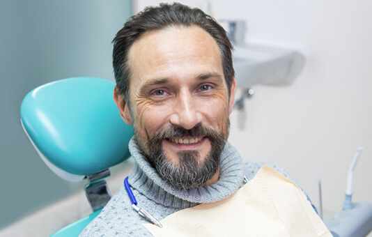 smiling man in a dental chair